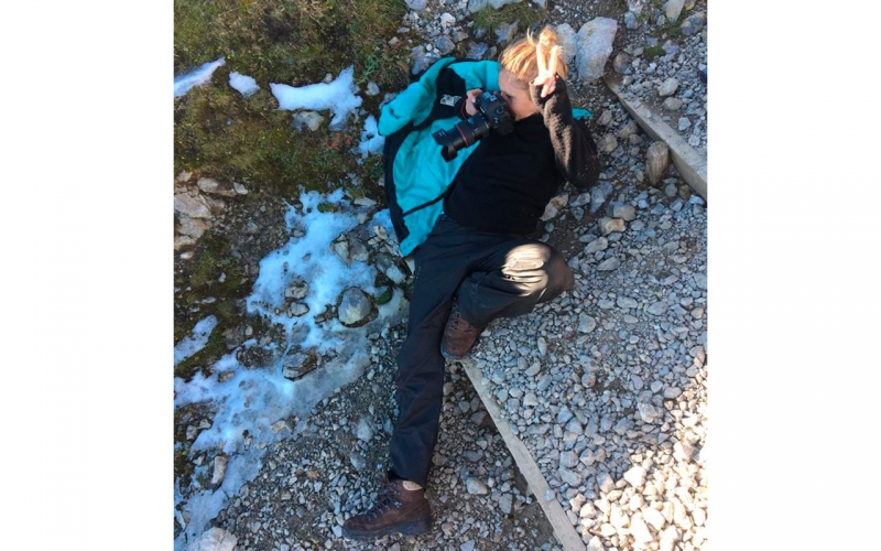 Cape Town photographer Jessica Zumpfe lying on the ground in the mounains while shooting