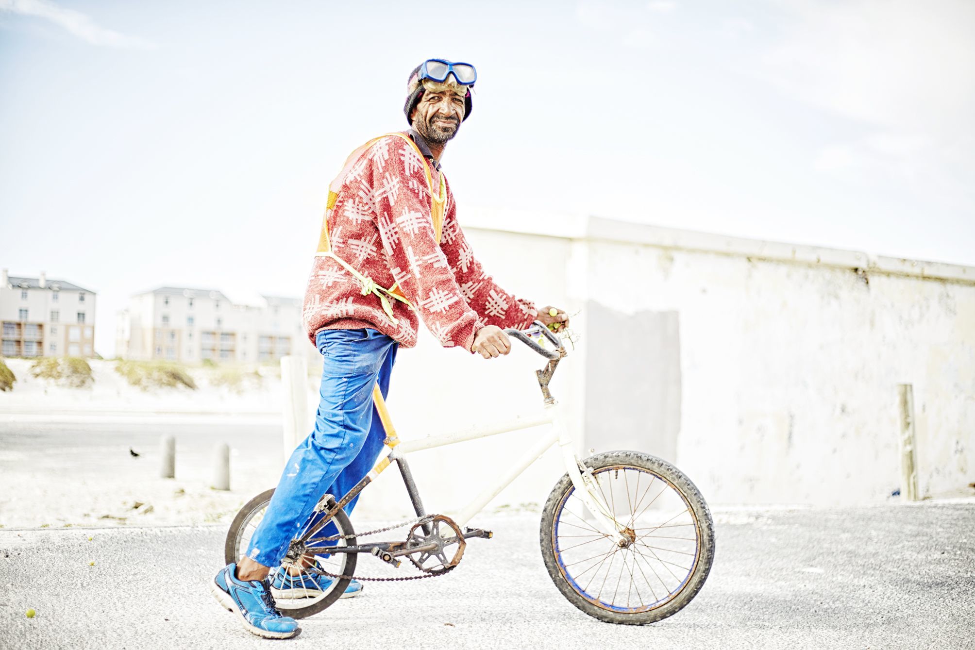 Portrait of Muizenberg's Car guard at the local kite spot sporting his bmx bike, goggles and some grapes.