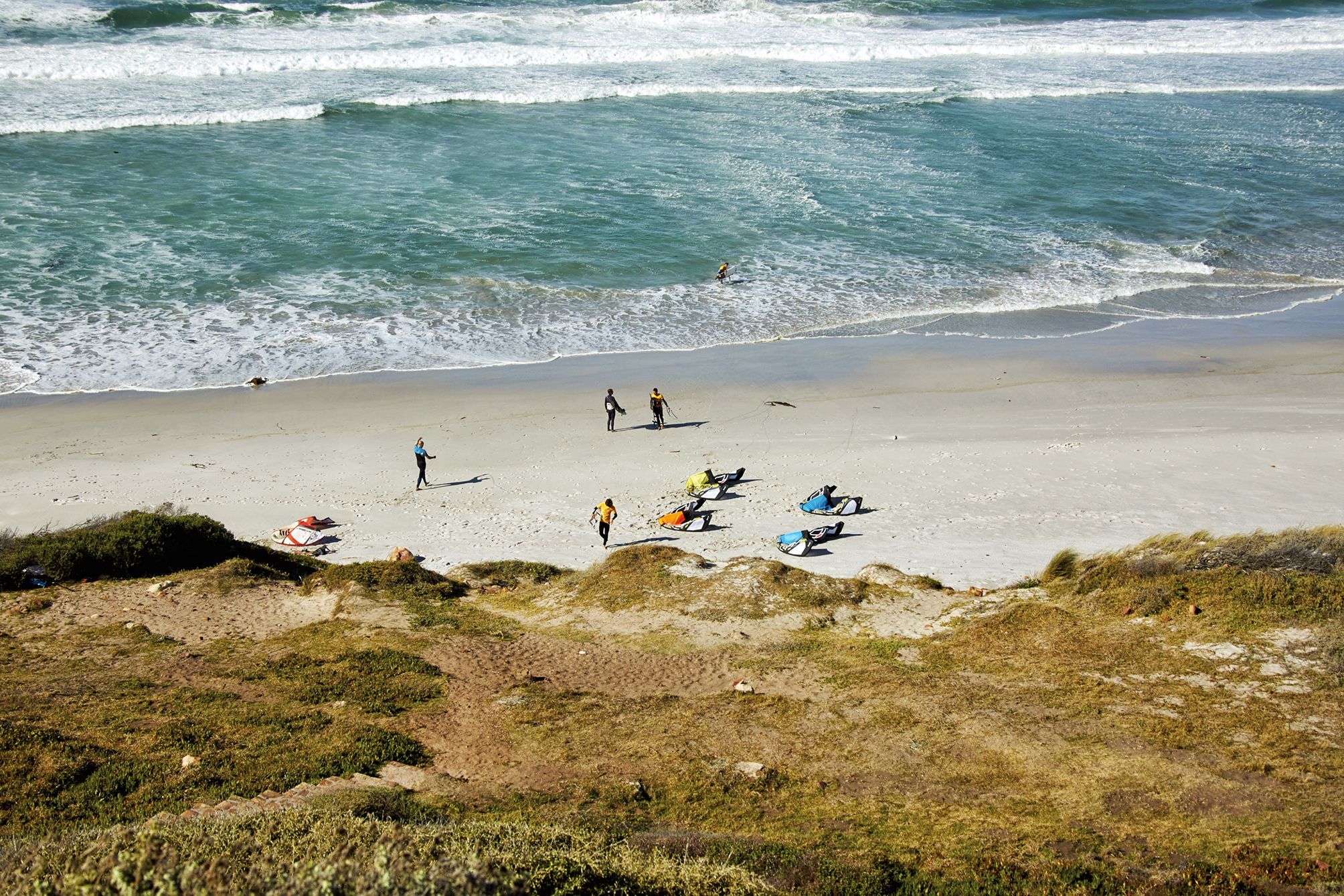 Top shot of four kites lying on the beach at witsands