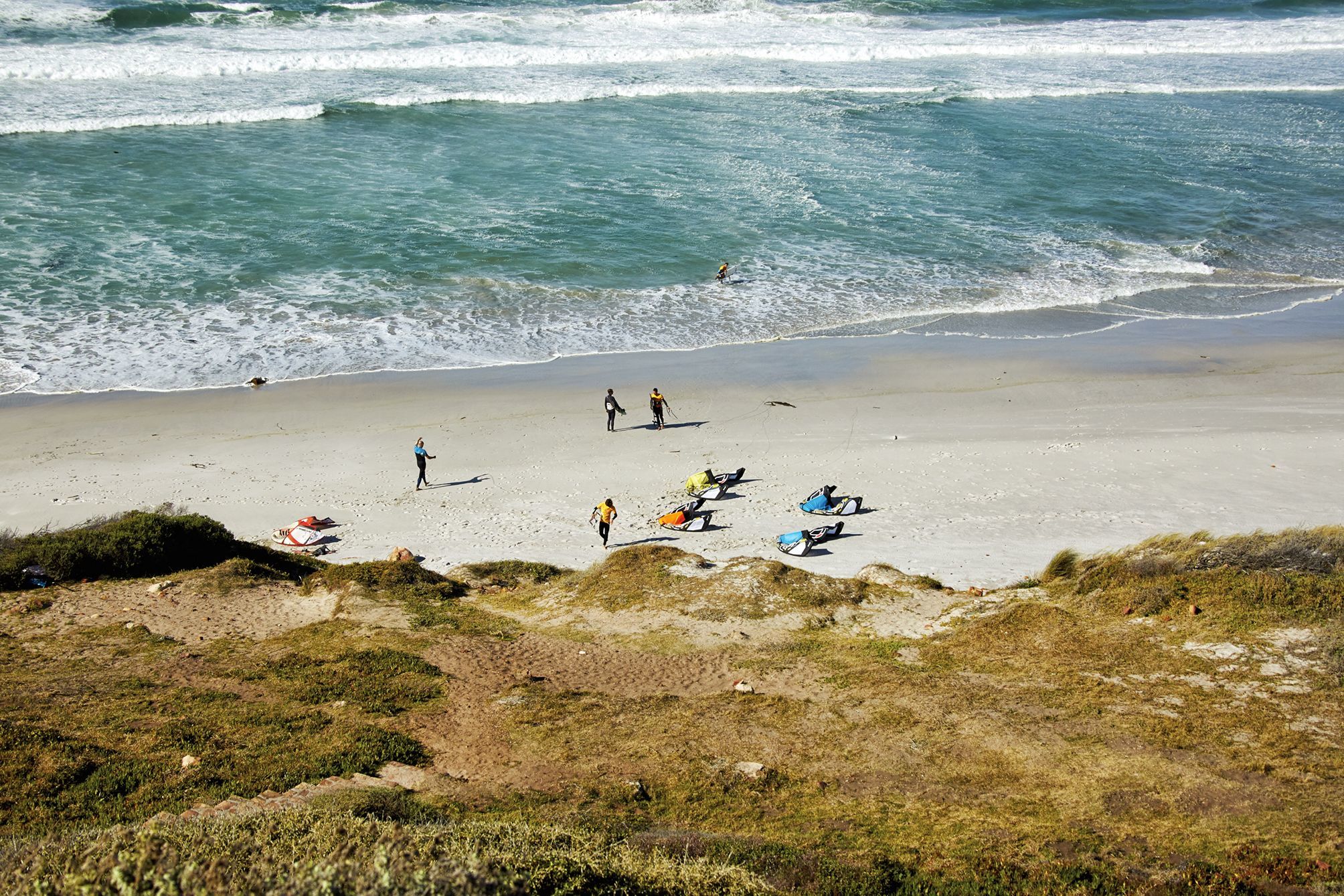 Top shot of four kites lying on the beach at witsands