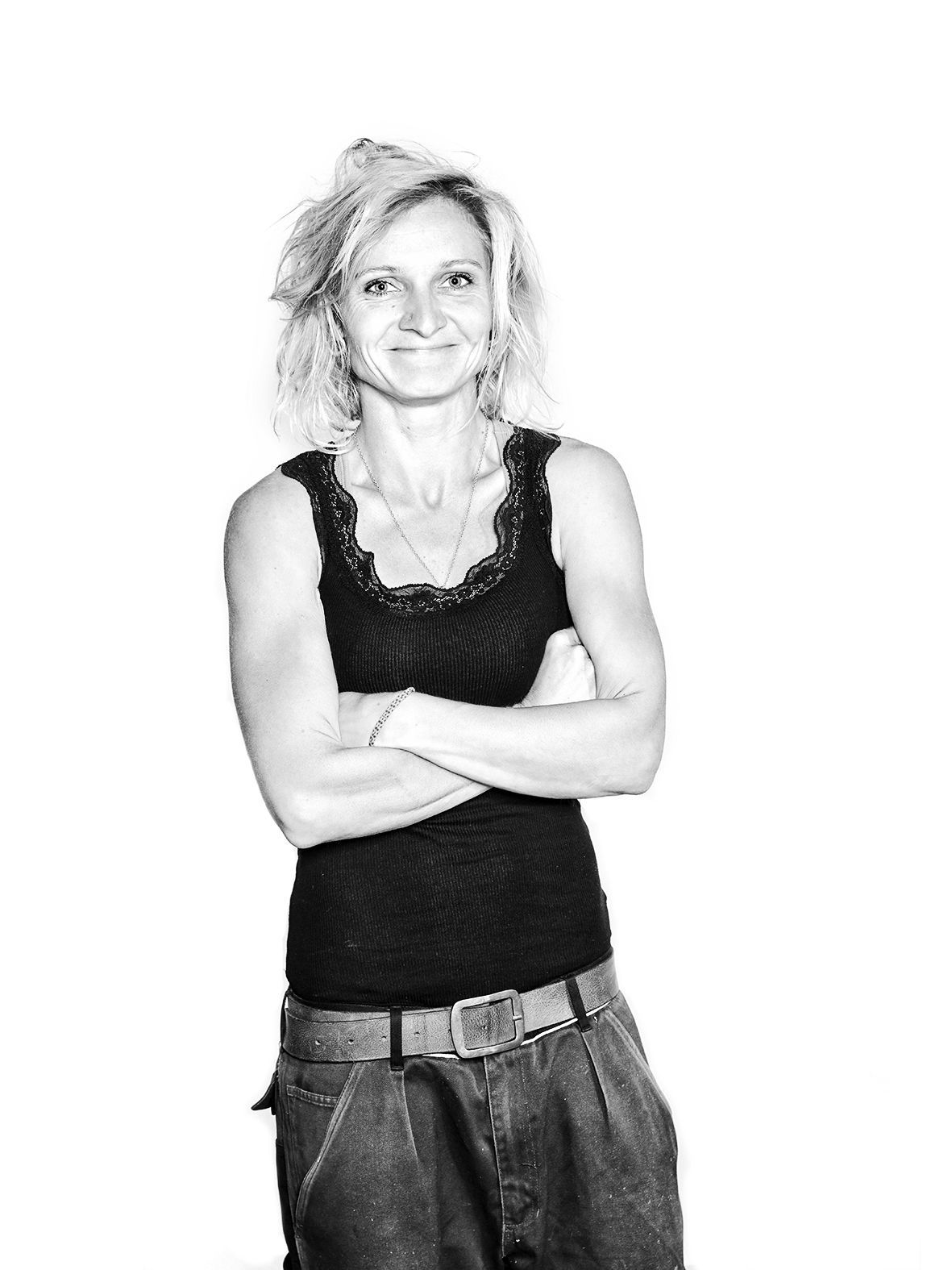 Portrait of the photographer Jessica Zumpe in her Mechanic clothes while working on her own car.