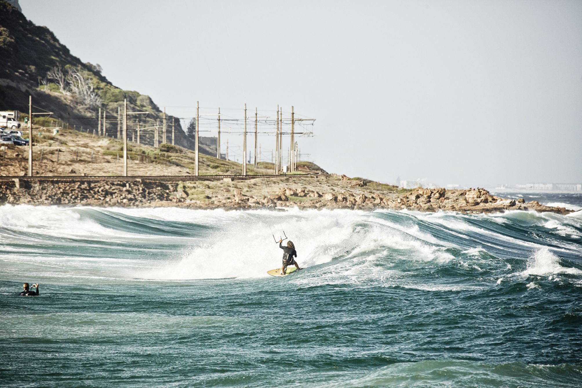 Kiter riding a wave at glencairn beach in cape town