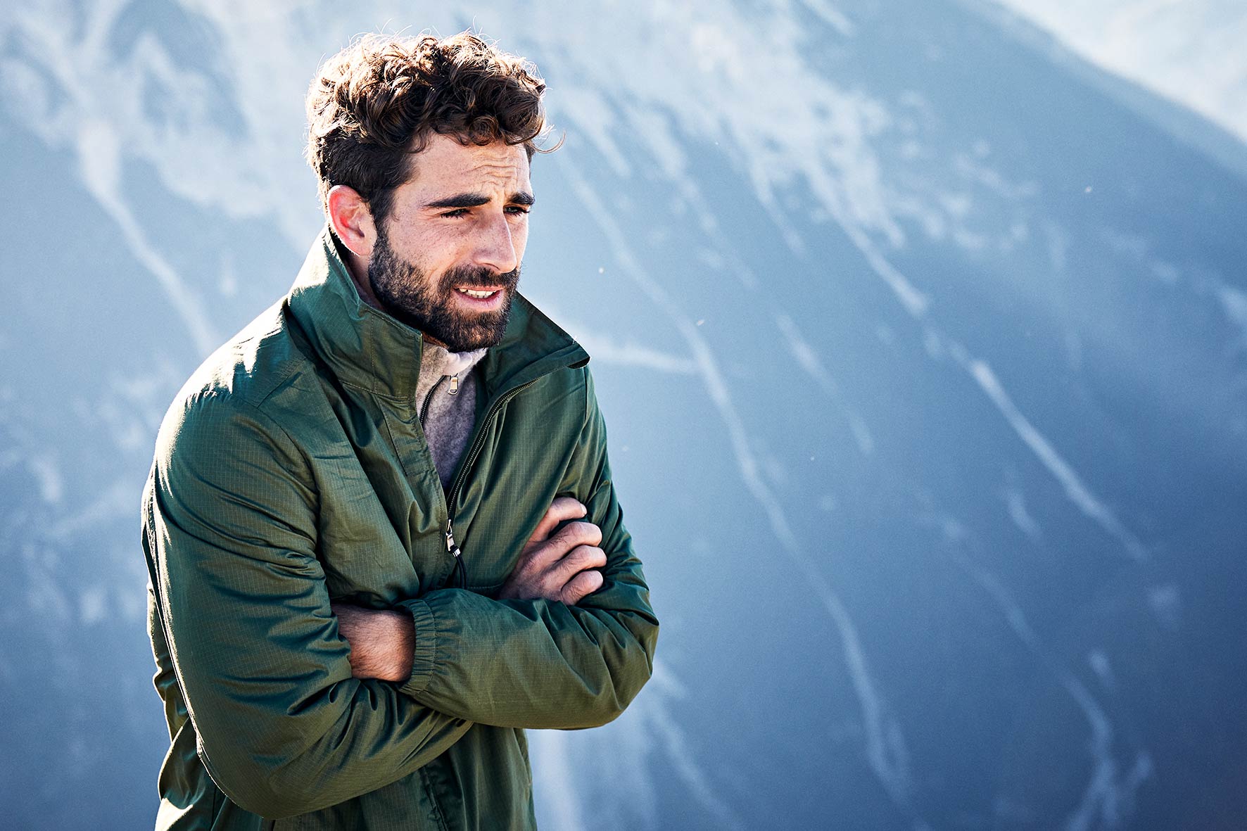 Athlete overlooking the mountain in the early morning in his active wear