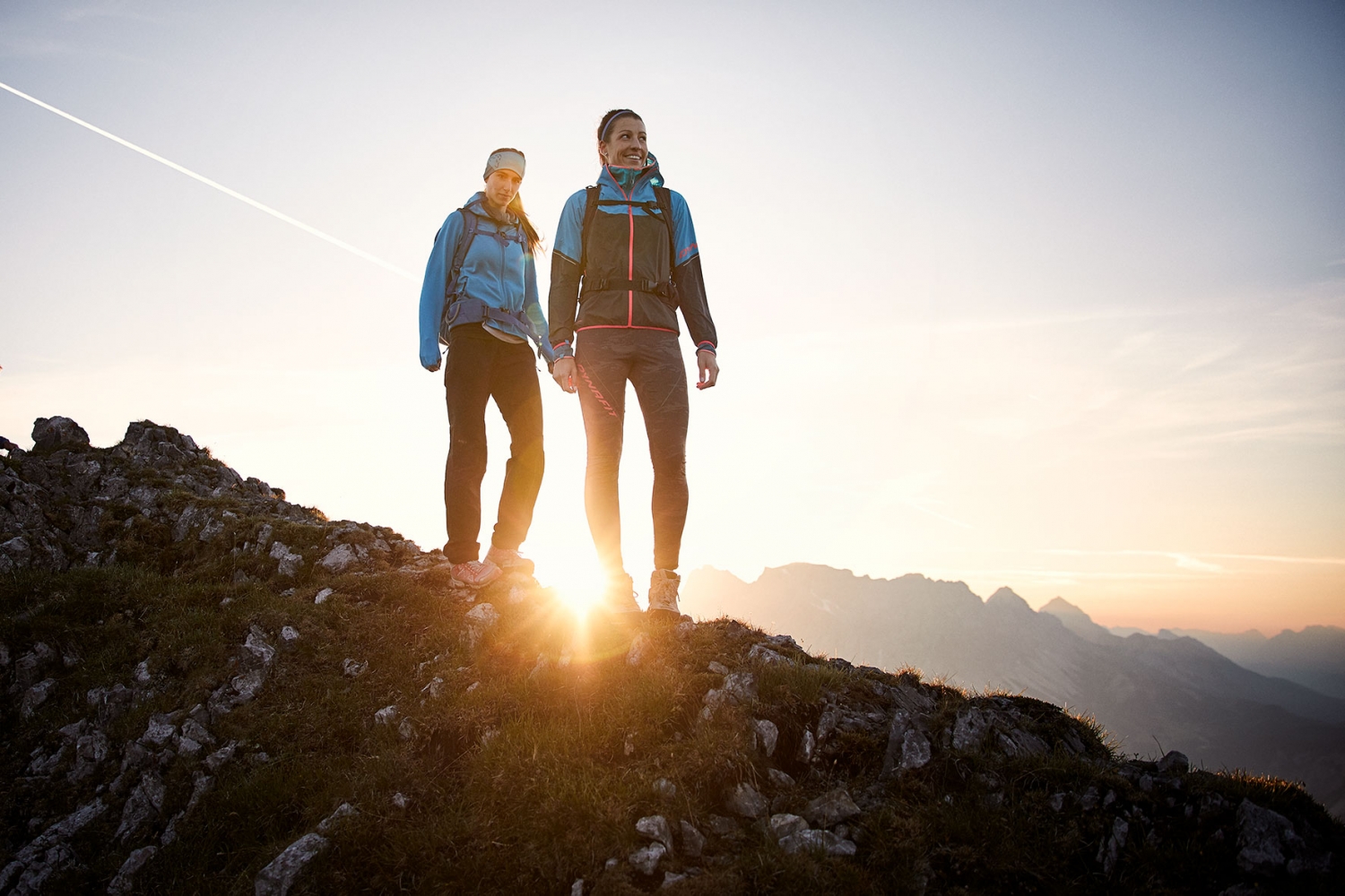 Two women standing ontop of a ridge at sunrise at Zugspitze