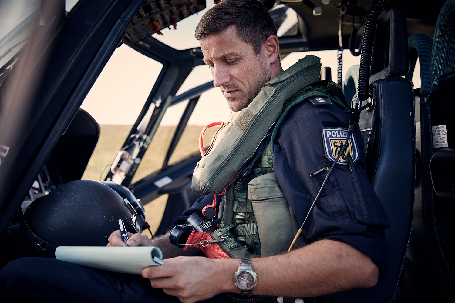 Federal Police pilot in the helicopter reading the training plan