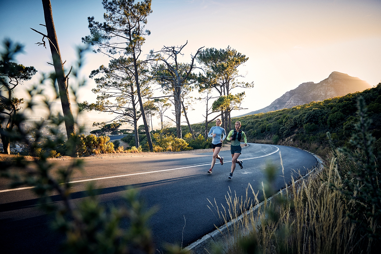 Two athletes training on the road by Table Mountain