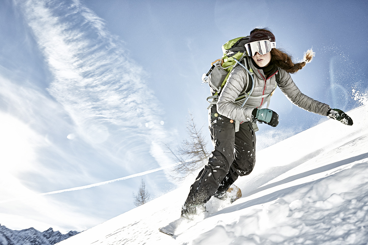 Woman snowboarder speeds down the mountain near Innsbruck