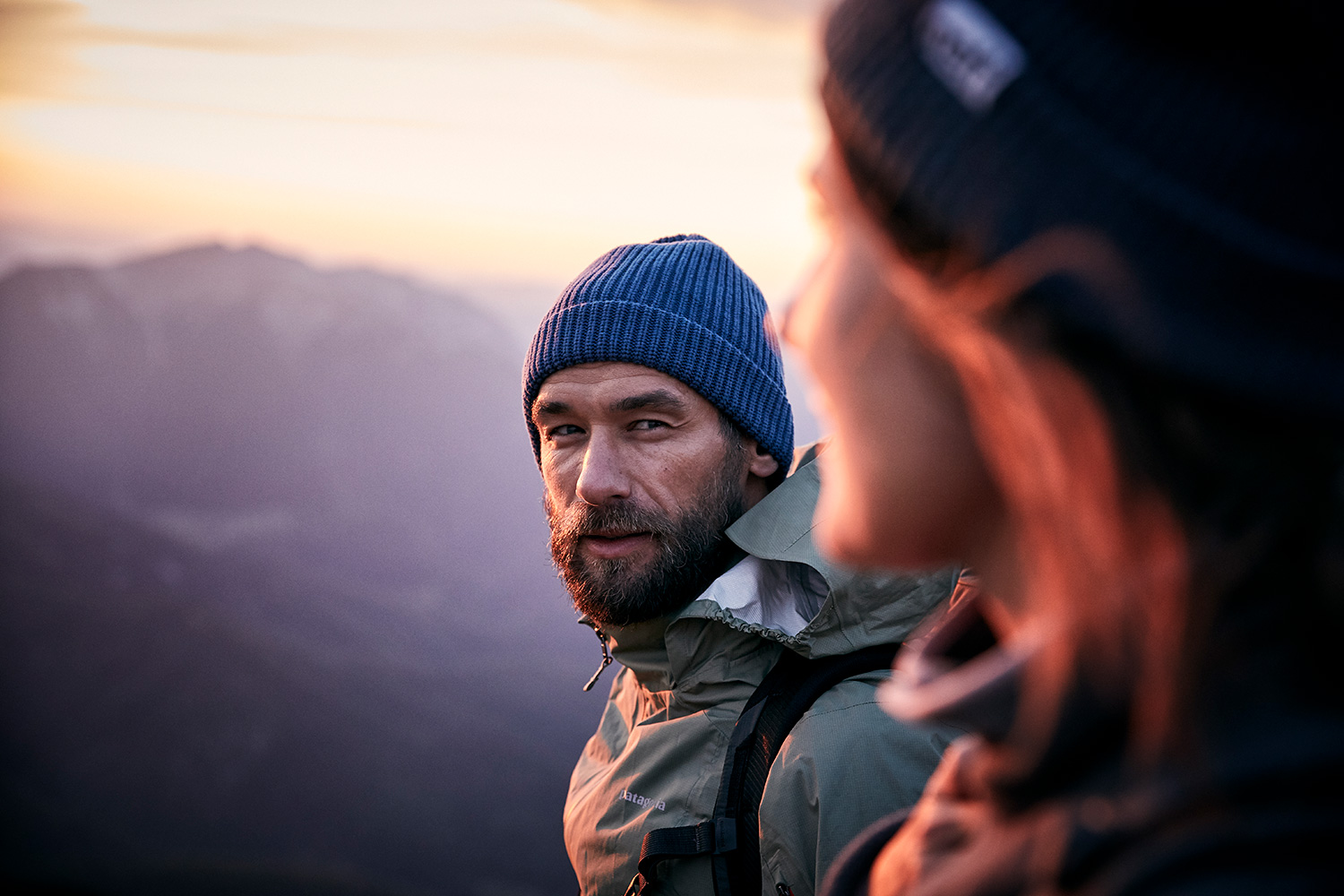 Portrait of a man looking at his girlfriend in the sunset ontop of Rofanspitze