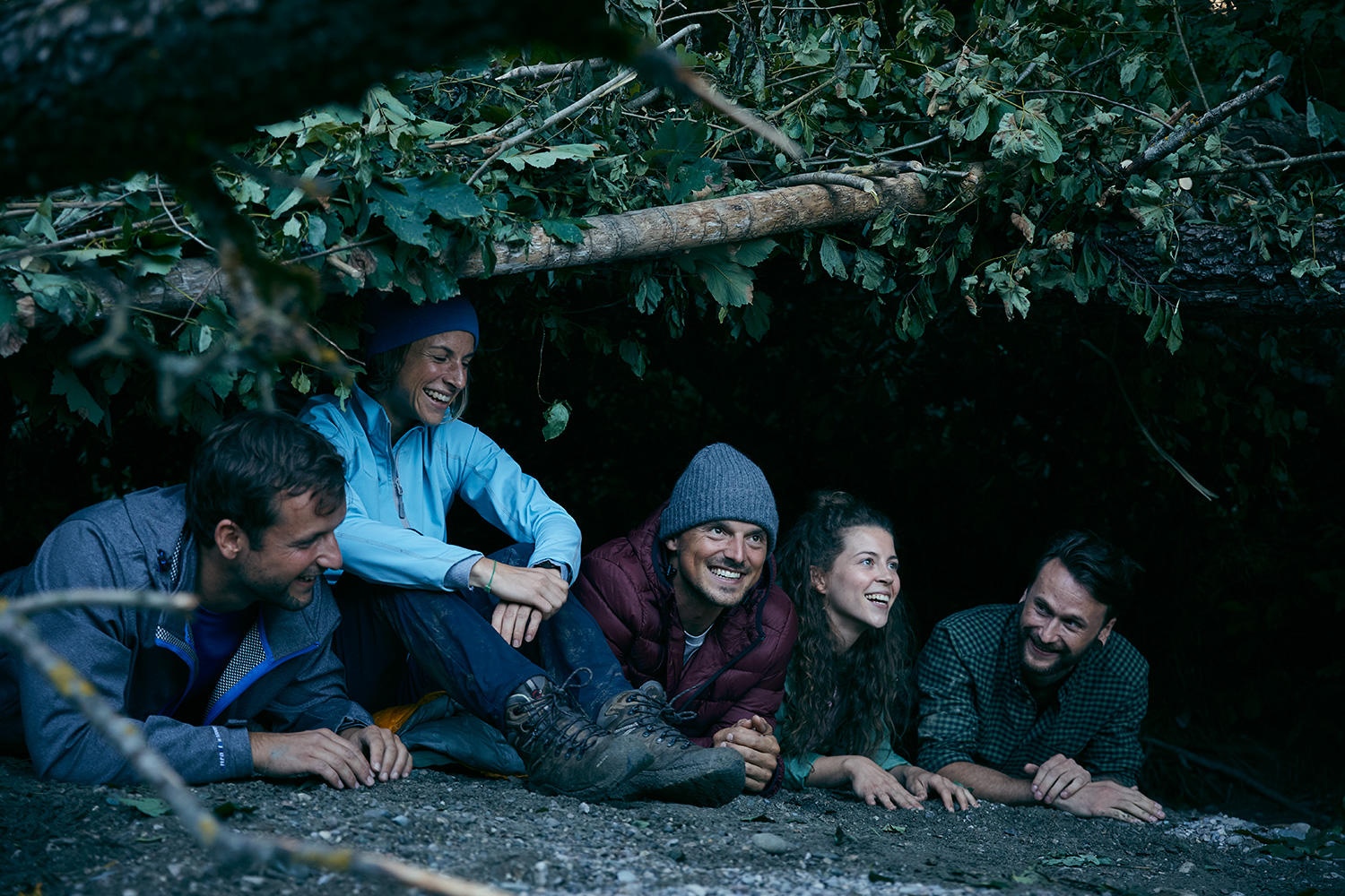 Five friends sitting in a storm shelter on a Jochen Schweizer Survival camp
