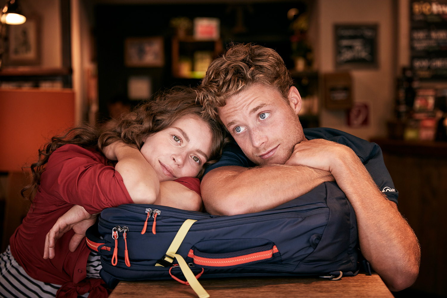 Portrait of Boy and girl leaning on their TATONKA backpack in a cafe