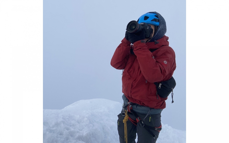 Jessica Zumpfe standing on the summit of the Grossglockner mountain on a photoshoot