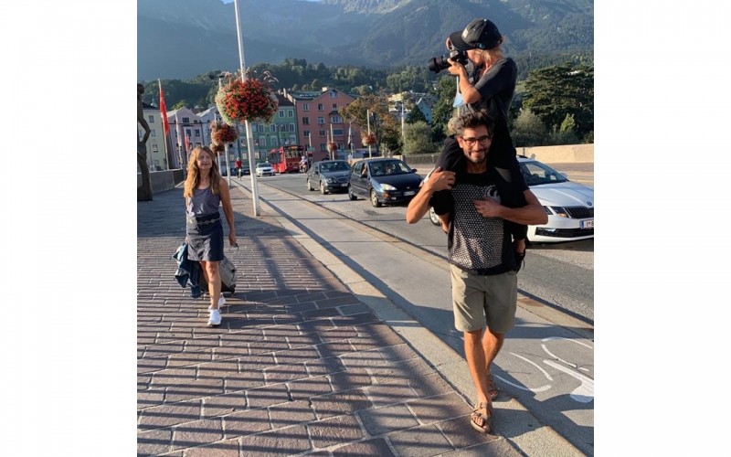 Jessica Zumpfe being carried on the shoulders of her assistant on a catalogue shoot for TATONKA