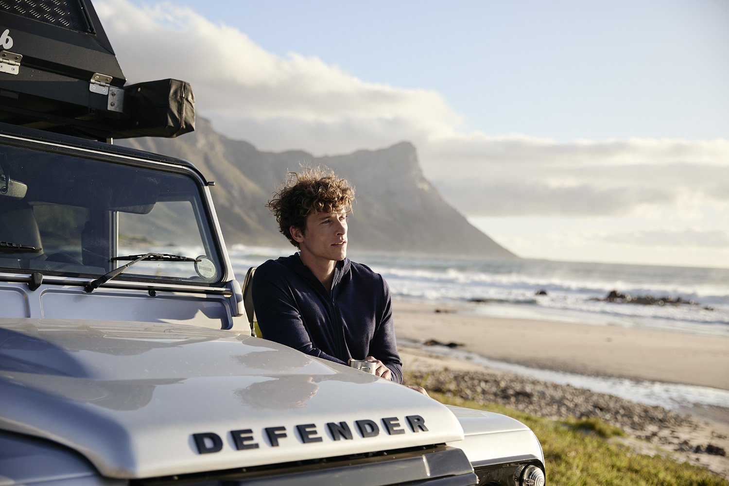 Man with his Defender on Kogelbaai Beach