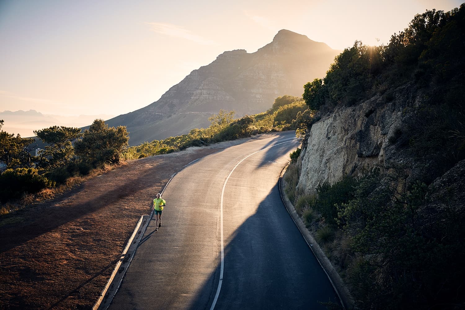 Athlete road running early in the morning along Table Mountain