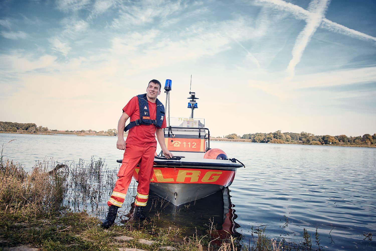 DLRG Lifeguard standing infront of the rescue boat