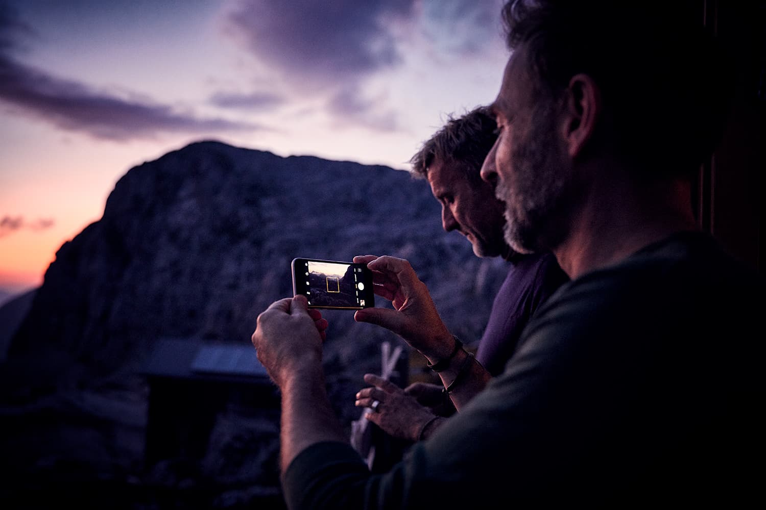 WALDEN Magazin Founders Harald Willenbrock and Markus Wolff enjoying the sunset ontop of the mountain on their first mountaineering tour