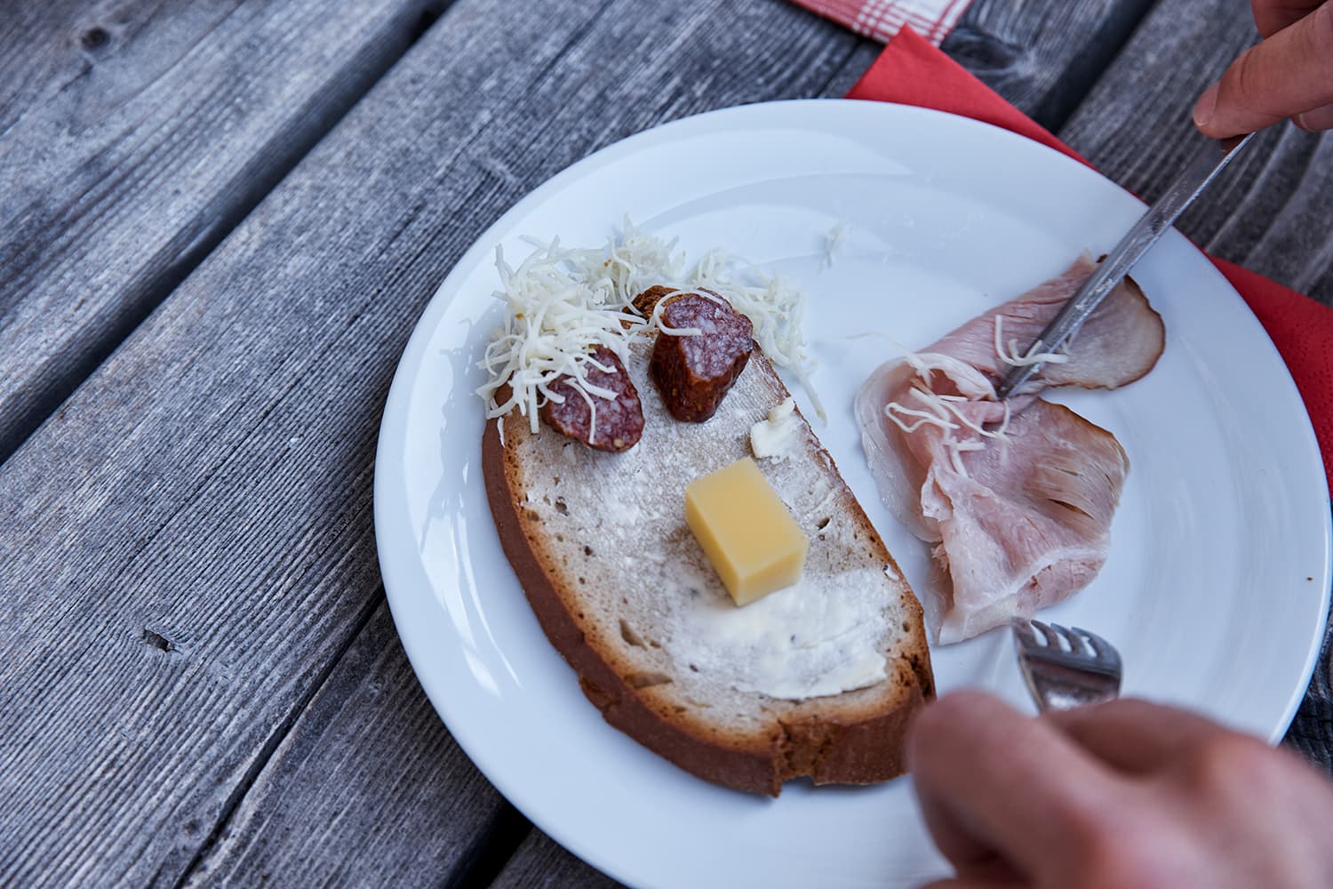 Bread and cheese spread on a plate to make a face